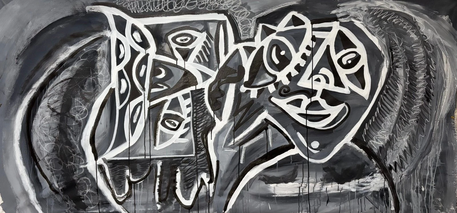 Dos formas de rostros de ojos grandes en trazos blancos y negros con goteos, sobre fondo gris oscuro rayado. Mujer y Toro. Acrílico sobre lienzo, 200 x 90 cm, 2026. Barcelona. Nicolás Lapadula